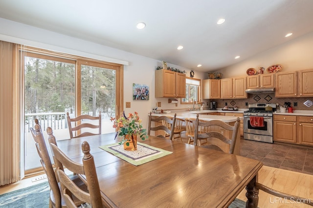 dining room with lofted ceiling, sink, and a wealth of natural light