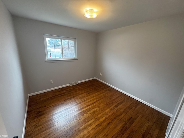 empty room featuring dark hardwood / wood-style flooring