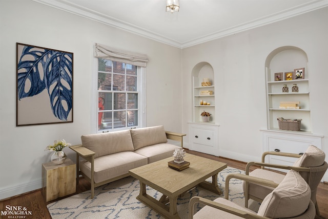 living room with hardwood / wood-style floors, crown molding, and built in features