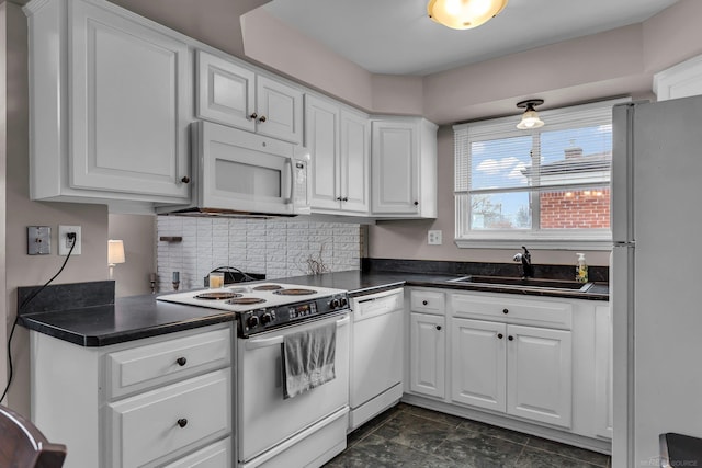 kitchen featuring sink, white appliances, white cabinets, and backsplash