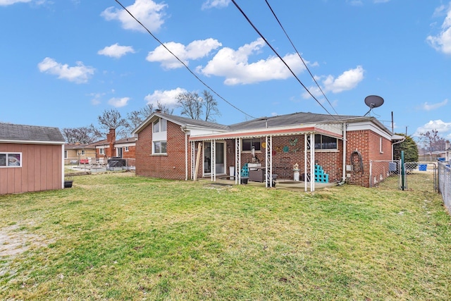 rear view of house with a patio and a lawn