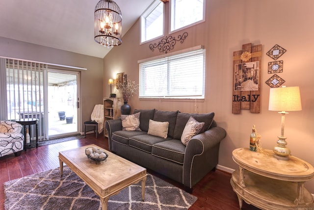 living room with high vaulted ceiling, dark hardwood / wood-style floors, and a chandelier