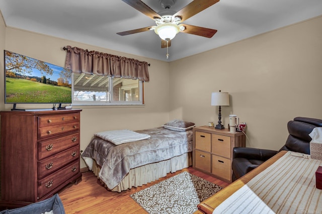 bedroom with light hardwood / wood-style floors and ceiling fan