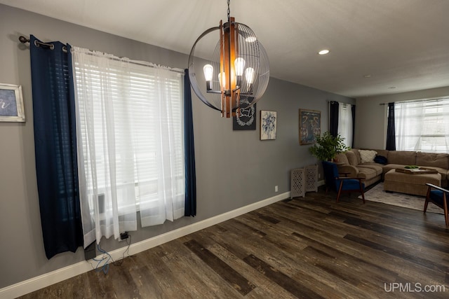 dining room featuring a notable chandelier and dark hardwood / wood-style flooring