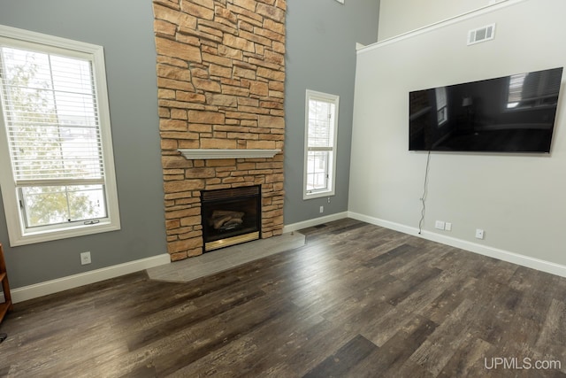 unfurnished living room with dark hardwood / wood-style flooring and a fireplace