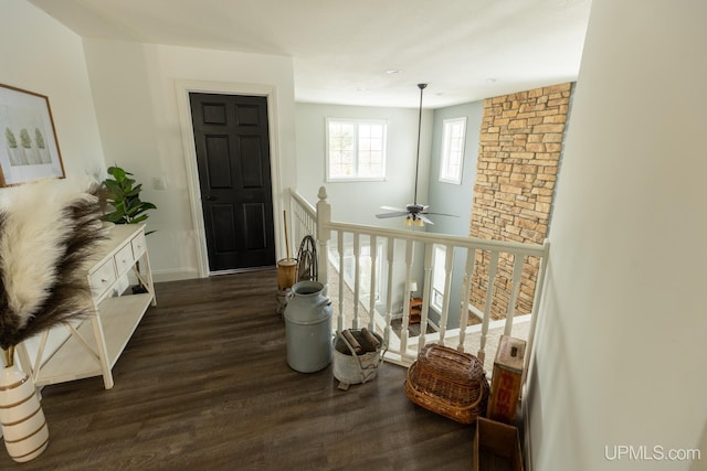 corridor with dark hardwood / wood-style flooring