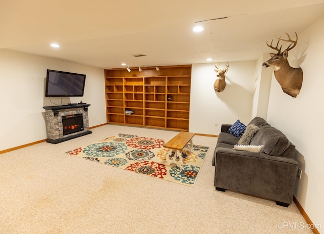 carpeted living room featuring a stone fireplace