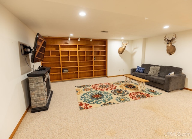 carpeted living room with track lighting