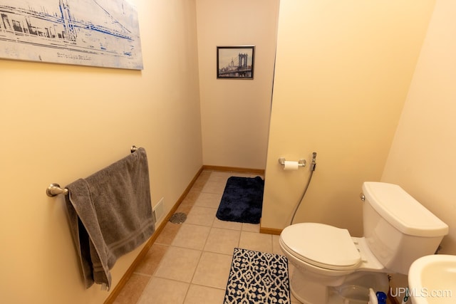 bathroom featuring toilet and tile patterned flooring