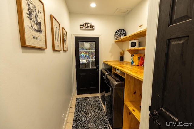 laundry room featuring separate washer and dryer and light tile patterned floors