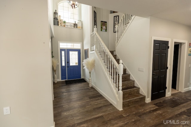 foyer entrance featuring dark hardwood / wood-style floors and a high ceiling