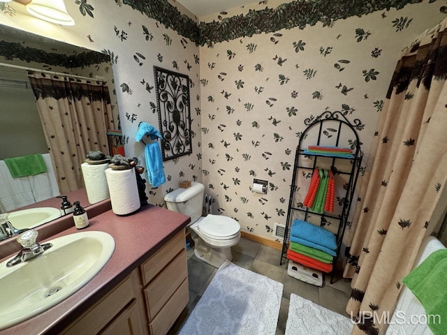 bathroom featuring tile patterned flooring, vanity, a shower with curtain, and toilet