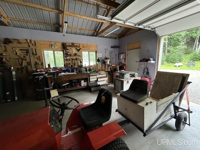 garage with a workshop area and electric panel