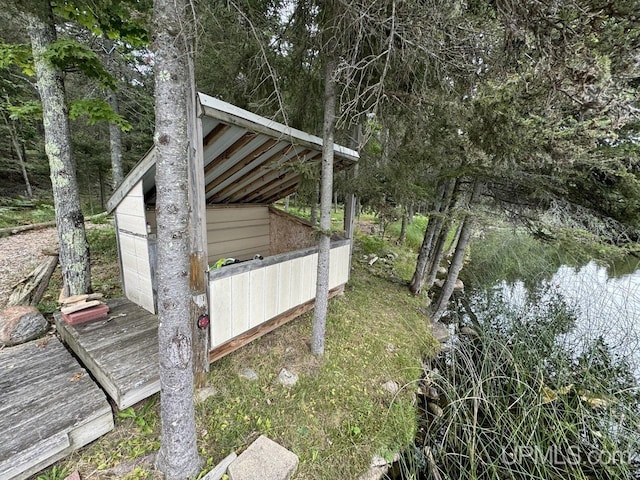 exterior space featuring a water view and a shed