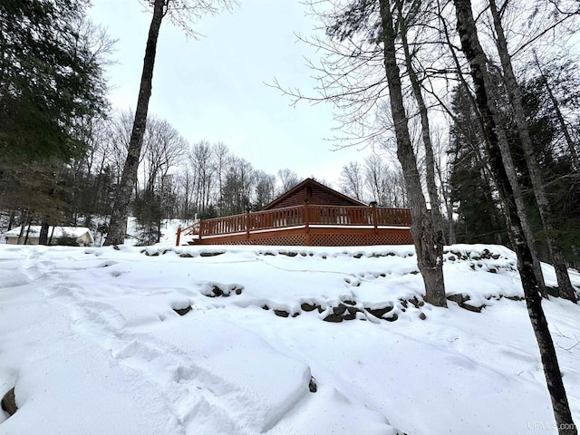 snowy yard with a wooden deck