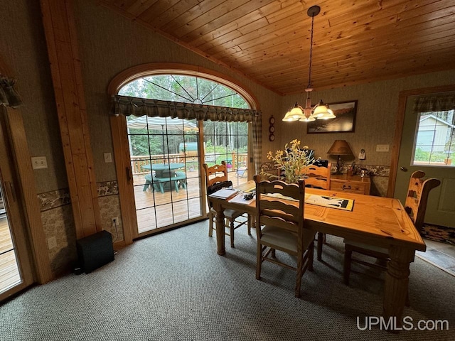 carpeted dining space featuring vaulted ceiling, wooden ceiling, and a chandelier