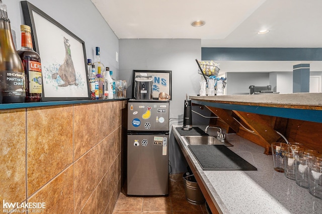 kitchen featuring tile patterned floors and stone countertops