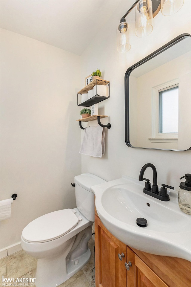 bathroom with tile patterned flooring, vanity, and toilet