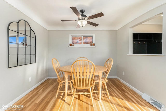 dining area with ceiling fan and light wood-type flooring