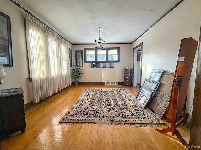 dining area with light hardwood / wood-style flooring and ornamental molding