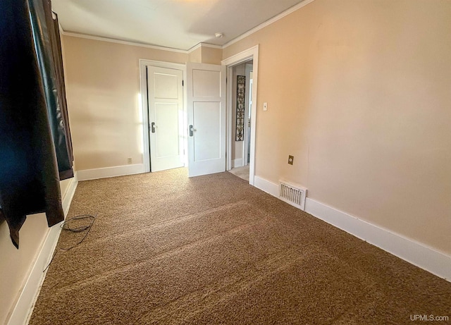 unfurnished bedroom with ornamental molding and carpet flooring