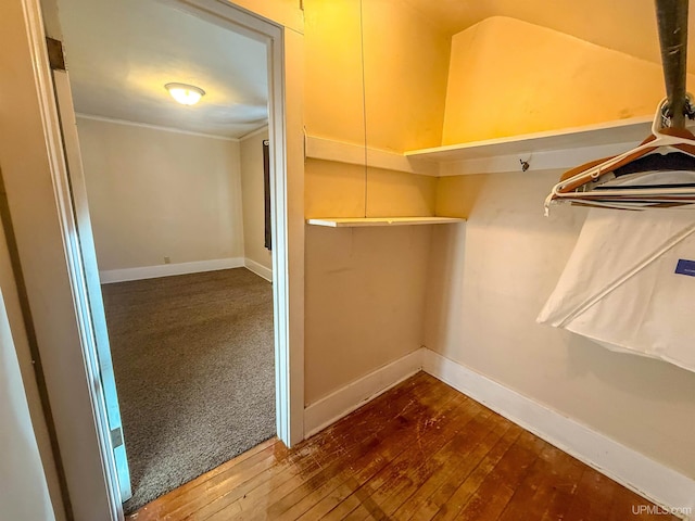 walk in closet with hardwood / wood-style flooring