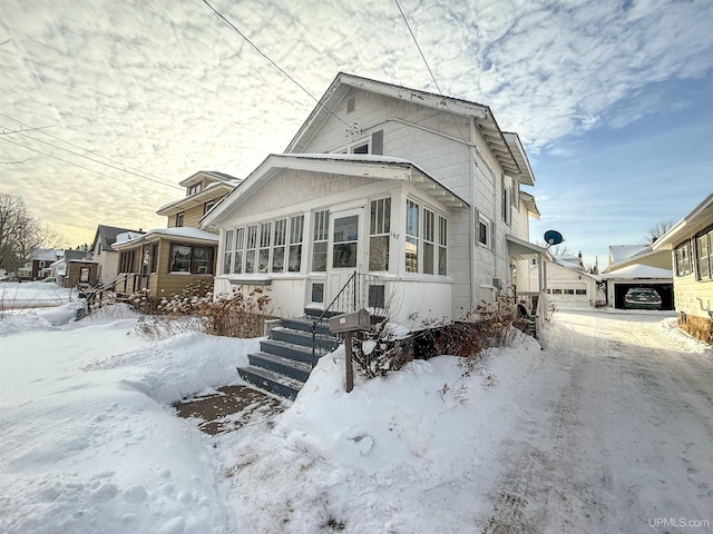 view of front of house featuring a garage and a sunroom