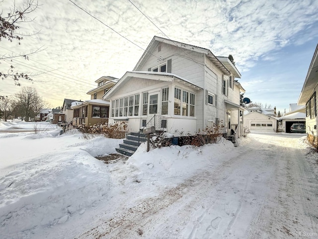 view of front of house with a garage and a sunroom