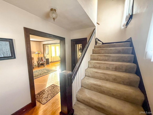 stairway featuring hardwood / wood-style floors