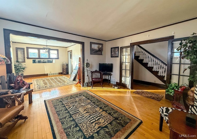 entrance foyer featuring crown molding and hardwood / wood-style floors