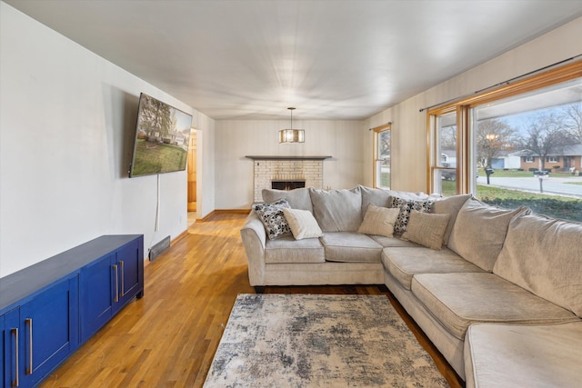 living room with hardwood / wood-style flooring and a fireplace