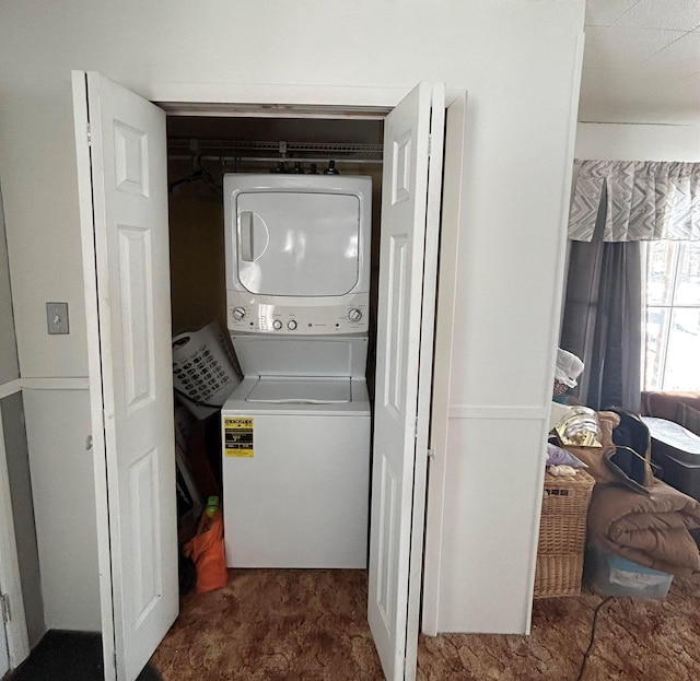 laundry area with stacked washer / dryer