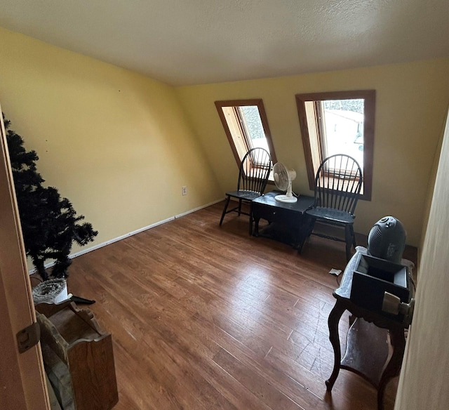 sitting room featuring wood-type flooring and a textured ceiling