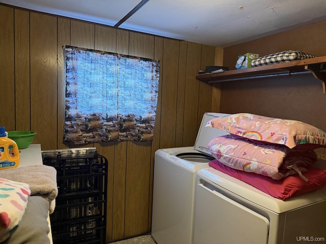 washroom featuring washer and dryer and wood walls