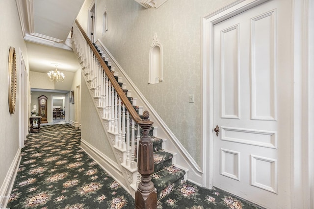 staircase featuring carpet floors and a chandelier