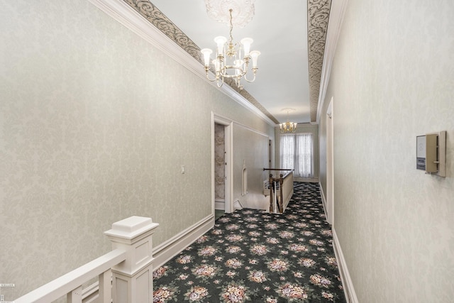 corridor with an inviting chandelier, carpet floors, and ornamental molding