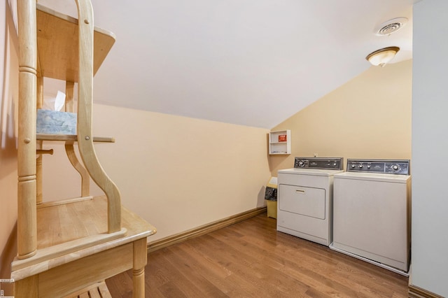 laundry room with hardwood / wood-style flooring and washer and clothes dryer