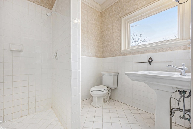 bathroom featuring tile walls, tile patterned flooring, tiled shower, ornamental molding, and toilet