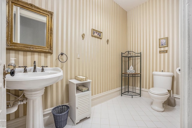 bathroom with sink, tile patterned floors, and toilet