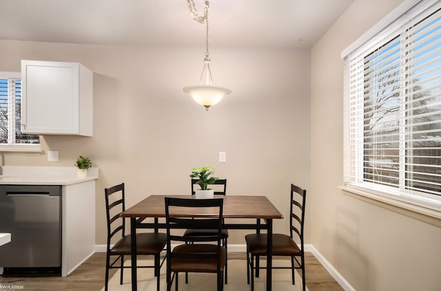 dining space with wood-type flooring