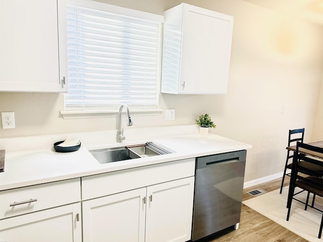 kitchen with white cabinetry, dishwasher, sink, and light hardwood / wood-style floors