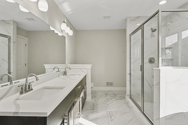 bathroom with vanity, toilet, and a shower with shower door