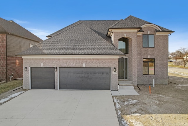 french provincial home with a garage