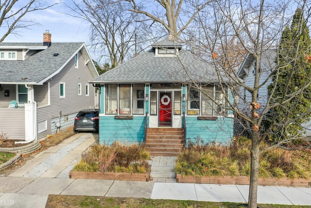 bungalow-style home with a sunroom