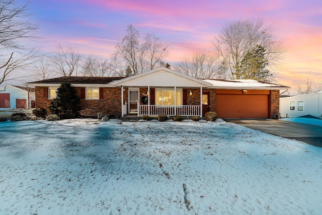 single story home featuring a garage and covered porch