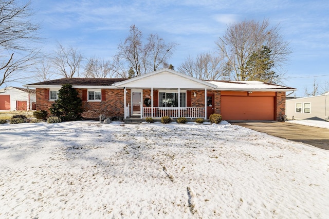 single story home featuring a porch and a garage