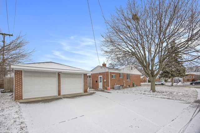 exterior space featuring an outbuilding, a garage, and central air condition unit