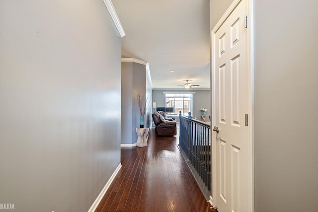 corridor with dark wood-type flooring and ornamental molding