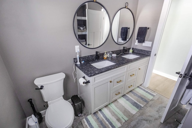 bathroom with hardwood / wood-style flooring, vanity, and toilet