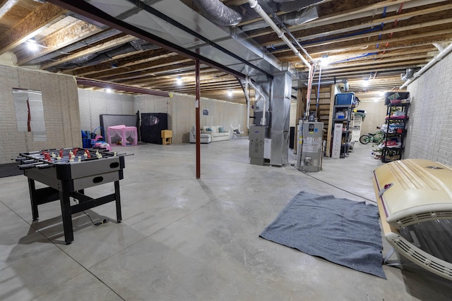 basement featuring heating unit, brick wall, and water heater